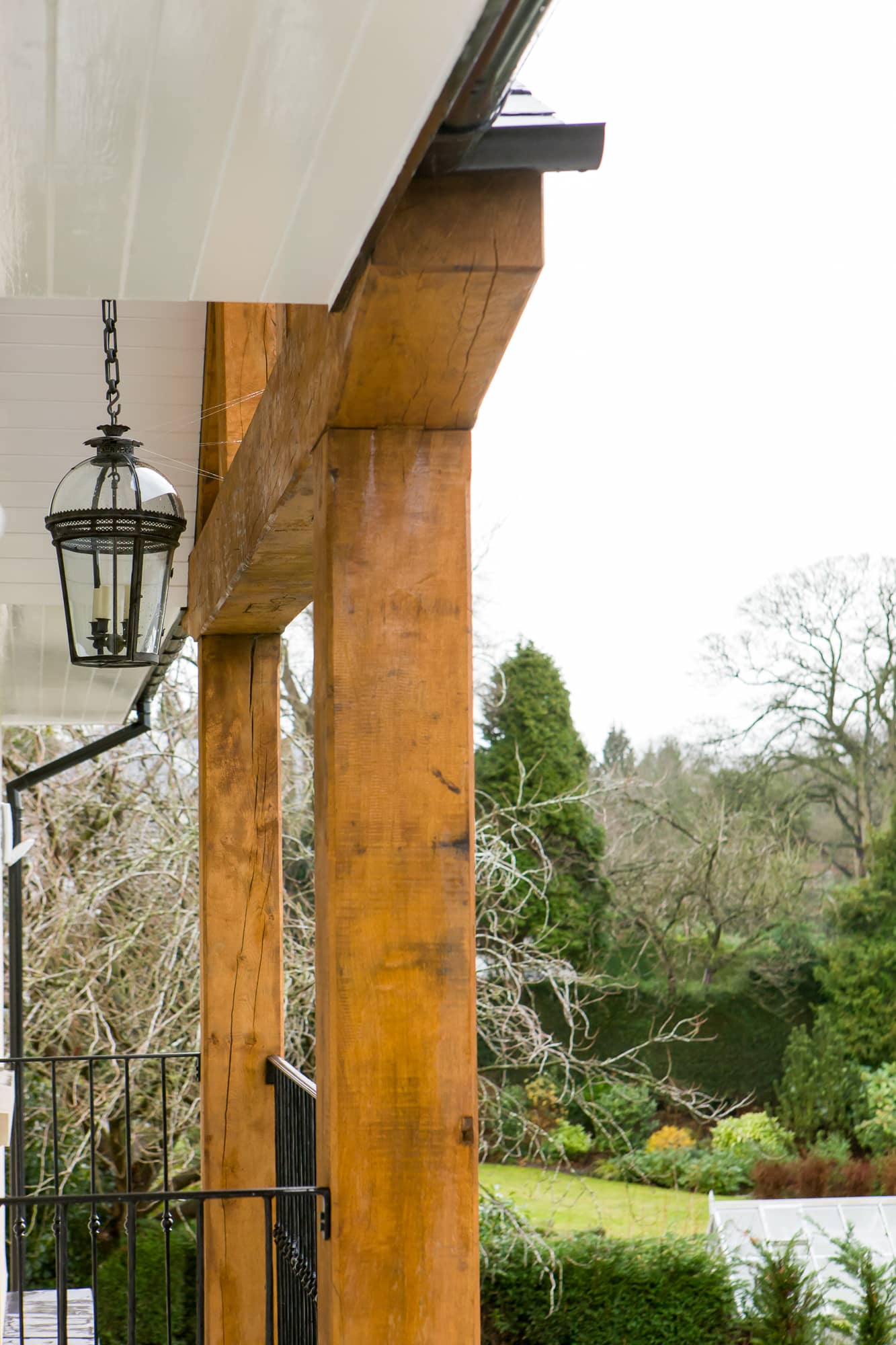 a porch with a light hanging from the ceiling.